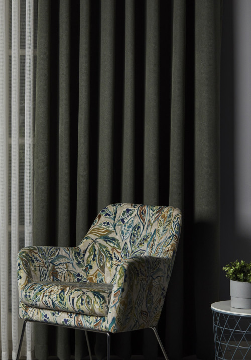 Dark curtains framing a furnished room
