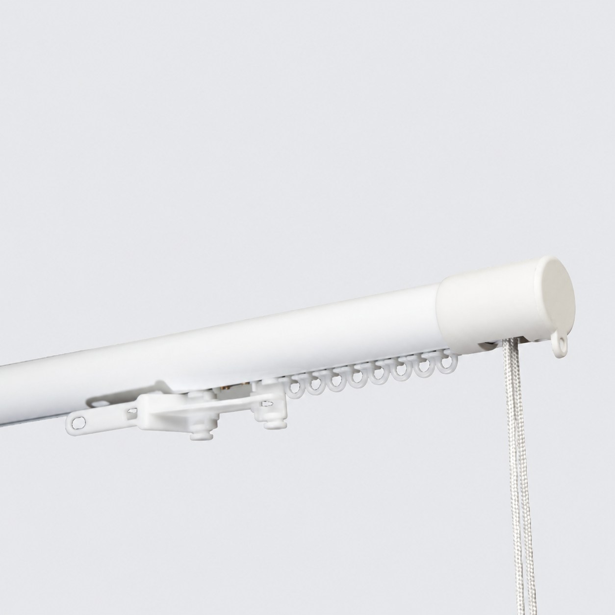 Rounded white cord drawn curtain track
